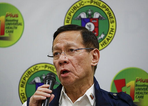 In this Feb. 6 photo, Philippine Health Secretary Francisco Duque III speaks during a press conference on the new coronavirus in Manila, Philippines on Thursday, Feb. 6, 2020. Duque is in home quarantine after being exposed to a health officer infected with the new coronavirus. For most people, the new coronavirus causes only mild or moderate symptoms. For some, it can cause more severe illness, especially in older adults and people with existing health problems. (AP Photo/Aaron Favila)