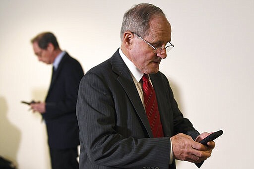 Sen. Jim Risch, R-Idaho, heads into a Republican policy lunch on Capitol Hill in Washington, Thursday, March 19, 2020. (AP Photo/Susan Walsh)