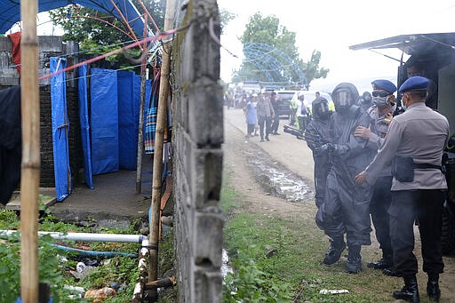 Paramilitary police officers disinfects a field where a mass congregation is supposed to be held in Gowa, South Sulawesi, Indonesia, Thursday, March 19, 2020. Indonesia halted the congregation of thousands of Muslim pilgrims and began quarantining and checking their health Thursday to prevent the spread of the new coronavirus. The vast majority of people recover from the new coronavirus. According to the World Health Organization, most people recover in about two to six weeks, depending on the severity of the illness. (AP Photo/Syaief)