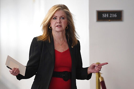 Sen. Marsha Blackburn, R-Tenn., heads into a Republican policy lunch on Capitol Hill in Washington, Thursday, March 19, 2020. (AP Photo/Susan Walsh)