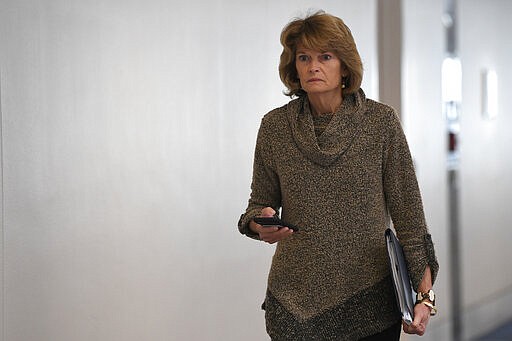 Sen. Lisa Murkowski, R-Alaska, heads into a Republican policy lunch on Capitol Hill in Washington, Thursday, March 19, 2020. (AP Photo/Susan Walsh)