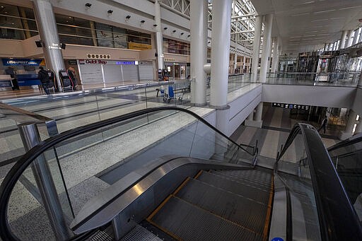 The departure area at Rafik Hariri International Airport is almost empty, in Beirut, Lebanon, Thursday, March 19, 2020. The Lebanese government decided to shut down the airport, ports and borders and ordered its citizens to stay home as the small country of nearly 5 million grappled with containing the coronavirus. (AP Photo/Hassan Ammar)