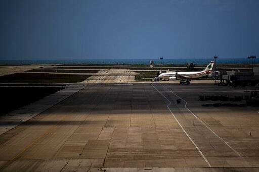 A Middle East Airlines jet is parked as no planes are using the Rafik Hariri International Airport in Beirut, Lebanon, Thursday, March 19, 2020. The Lebanese government decided to shut down the airport, ports and borders and ordered its citizens to stay home as the small country of nearly 5 million grappled with containing the coronavirus. (AP Photo/Hassan Ammar)