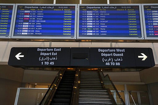 The departures board at Rafik Hariri International Airport shows cancelled flights, in Beirut, Lebanon, Thursday, March 19, 2020. The Lebanese government decided to shut down the airport, ports and borders and ordered its citizens to stay home as the small country of nearly 5 million grappled with containing the coronavirus. (AP Photo/Hassan Ammar)