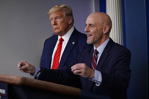 President Donald Trump, left, listens as Food and Drug Administration Commissioner Dr. Stephen Hahn speaks during press briefing with the coronavirus task force, at the White House, Thursday, March 19, 2020, in Washington. (AP Photo/Evan Vucci)