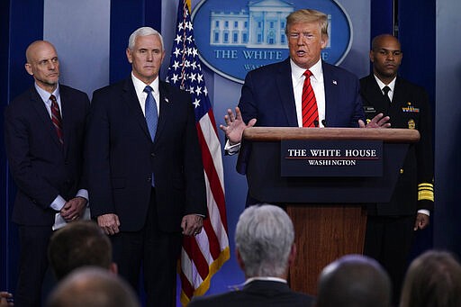 President Donald Trump speaks during press briefing with the coronavirus task force, at the White House, Thursday, March 19, 2020, in Washington. From left, Food and Drug Administration Commissioner Dr. Stephen Hahn, Vice President Mike Pence, Trump, and Surgeon General Jerome Adams. (AP Photo/Evan Vucci)