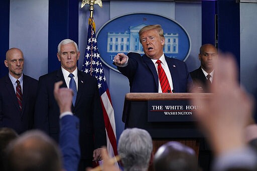 President Donald Trump takes questions during press briefing with the coronavirus task force, at the White House, Thursday, March 19, 2020, in Washington. From left, Food and Drug Administration Commissioner Dr. Stephen Hahn, Vice President Mike Pence, Trump and Surgeon General Jerome Adams. (AP Photo/Evan Vucci)