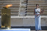 Flame arrival faces calls for Tokyo Olympics be delayed