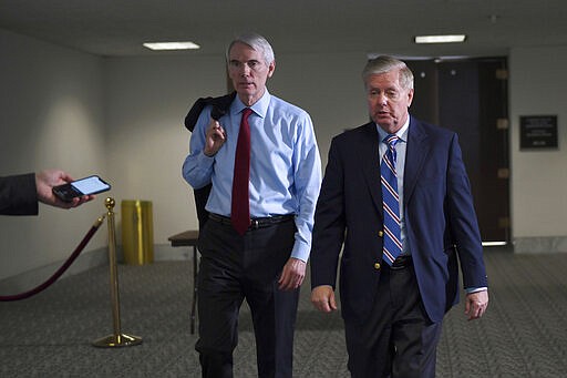 Sen. Rob Portman, R-Ohio,, left, and Sen. Lindsey Graham, R-S.C., right, leave a Republican policy lunch on Capitol Hill in Washington, Thursday, March 19, 2020. (AP Photo/Susan Walsh)