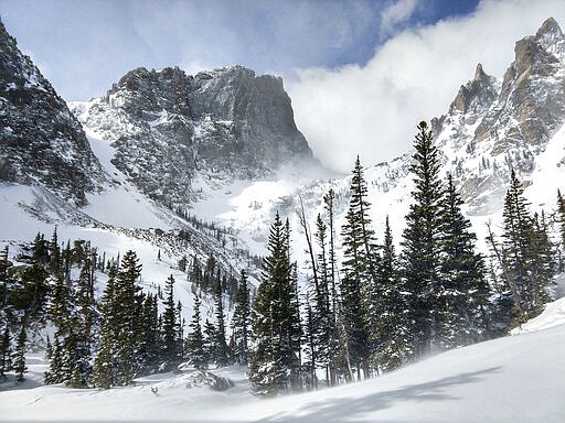 This March 12, 2020 photo provided by Katarina Takahashi shows Emerald Lake in Rocky Mountain National Park, Colo. Most national parks are open as a refuge for Americans tired of being stuck at home because of the coronavirus. Entry fees have been eliminated, but many parks are closing visitor centers, shuttles and lodges to fight the spread of the virus. (Katarina Takahashi via AP)