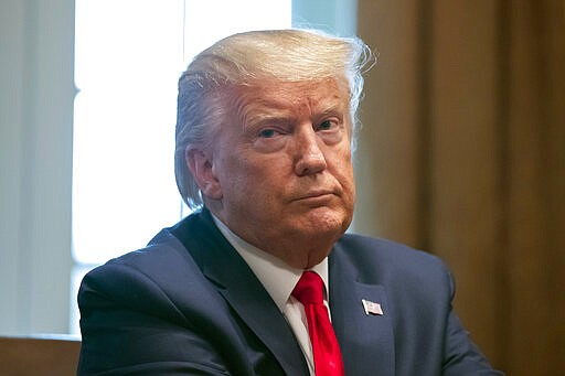 President Donald Trump listens as others speak about the coronavirus in the Cabinet Room of the White House during a meeting with representatives of American nurses, Wednesday, March 18, 2020, in Washington. (AP Photo/Alex Brandon)