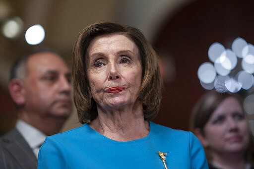 Speaker of the House Nancy Pelosi, D-Calif., pauses as she makes a statement ahead of a planned late-night vote on the coronavirus aid package deal at the Capitol in Washington, Friday, March 13, 2020. (AP Photo/J. Scott Applewhite)