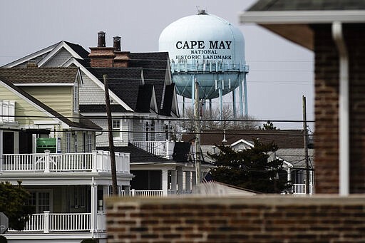 A water tower stands beyond residences in Cape May, N.J., Wednesday, March 18, 2020. Some people who live in cities or their suburbs have been fleeing to their second homes at the shore to ride out the coronavirus near the beach. But neighbors in many of those towns are yanking the welcome mat, fearing infection and an overwhelming of already-stretched resources.  (AP Photo/Matt Rourke)