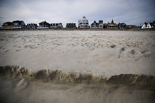 Homes overlook the beach in Cape May, N.J., Wednesday, March 18, 2020. Some people who live in cities or their suburbs have been fleeing to their second homes at the shore to ride out the coronavirus near the beach. But neighbors in many of those towns are yanking the welcome mat, fearing infection and an overwhelming of already-stretched resources. (AP Photo/Matt Rourke)