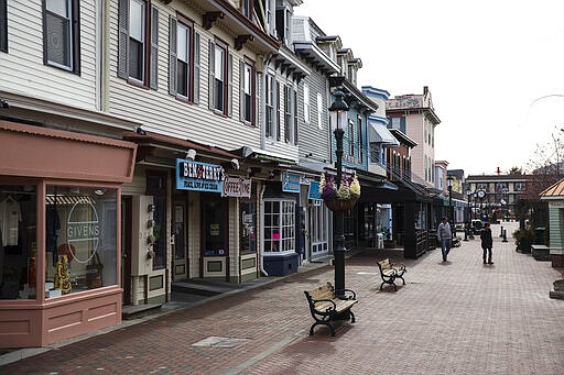 People visit the Washington Street Mall in Cape May, N.J., Wednesday, March 18, 2020. Some people who live in cities or their suburbs have been fleeing to their second homes at the shore to ride out the coronavirus near the beach. But neighbors in many of those towns are yanking the welcome mat, fearing infection and an overwhelming of already-stretched resources. (AP Photo/Matt Rourke)