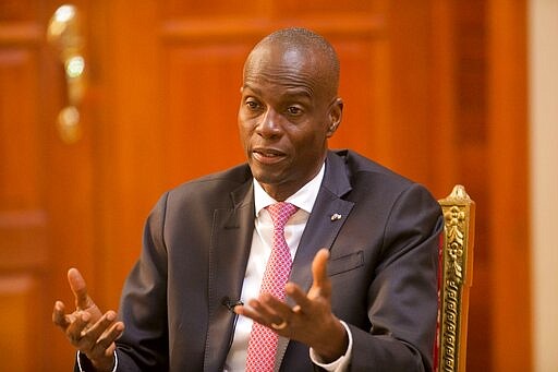 FILE - In this Feb. 7, 2020 file photo, Haiti's President Jovenel Moise speaks during an interview at his home in Petion-Ville, a suburb of Port-au-Prince, Haiti. Moise said Thursday, March 19, 2020, that two patients had been quarantined after testing positive for the COVID-19 virus. One was a 31-year-old Haitian who had just returned from Paris and the other was a Belgian volunteering in a Port-au-Prince orphanage. (AP Photo/Dieu Nalio Chery, File)