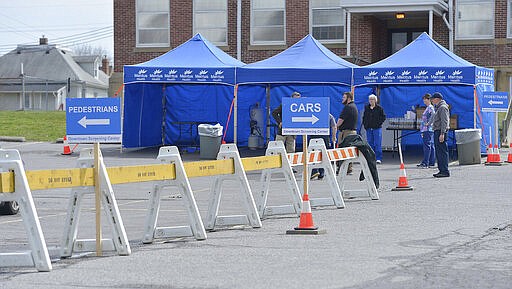 A Meritus Health screening center is set up in the parking lot of the former Surrey School on Virginia Avenue in Hagerstown, Md., Thursday, March 19, 2020. According to Meritus spokeswoman Joelle Butler, the site is not yet open. The hope is to open next week.  (Colleen McGrath/The Herald-Mail via AP)