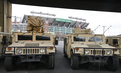 A number of armored transports sit parked in the lot between Camden Yards and M&amp;T Bank Stadium in Baltimore, M.D. The National Guard has been deployed in Maryland. (Ulysses Mu&ntilde;oz/The Baltimore Sun via AP)