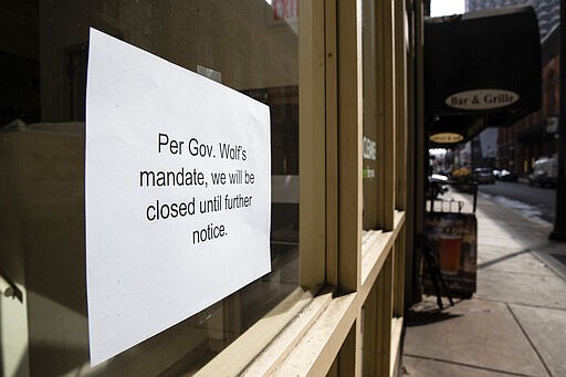 A sign is posted in the window of a closed business in Philadelphia, Friday, March 20, 2020.  Pennsylvania Gov. Tom Wolf directed all &quot;non-life-sustaining&quot; businesses to close their physical locations late Thursday and said state government would begin to enforce the edict starting early Saturday. (AP Photo/Matt Rourke)