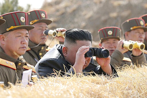 In this Friday, March 20, 2020, photo provided by the North Korean government, North Korean leader Kim Jong Un supervises an artillery firing competition between army units in the country's west in North Korea. Independent journalists were not given access to cover the event depicted in this image distributed by the North Korean government. The content of this image is as provided and cannot be independently verified. (Korean Central News Agency/Korea News Service via AP)