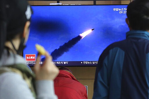 People watches a televsion screen showing a file image of North Korea's missile launch during a news program at the Seoul Railway Station in Seoul, South Korea, Saturday, March 21, 2020. North Korea on Saturday fired two presumed short-range ballistic missiles into the sea, South Korea's military said, as it continues to expand military capabilities amid deadlocked nuclear negotiations with the Trump administration and a crippling global health crisis. (AP Photo/Ahn Young-joon)