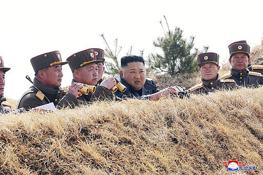 In this Friday, March 20, 2020, photo provided by the North Korean government, North Korean leader Kim Jong Un supervises an artillery firing competition between army units in the country's west in North Korea. Independent journalists were not given access to cover the event depicted in this image distributed by the North Korean government. The content of this image is as provided and cannot be independently verified. Korean language watermark on image as provided by source reads: &quot;KCNA&quot; which is the abbreviation for Korean Central News Agency. (Korean Central News Agency/Korea News Service via AP)