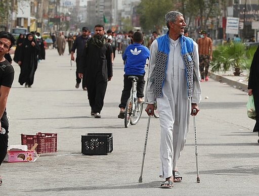 Although shrines are closed due to the new coronavirus, Shiite pilgrims make their way to the shrine of Imam Moussa al-Kadhim, a key Shiite saint, during preparations for the annual commemoration of his death, in Baghdad, Iraq Friday, March 20, 2020. Iraq announced a weeklong curfew to help fight the spread of the virus. For most people, the virus causes only mild or moderate symptoms. For some it can cause more severe illness. (AP Photo/Hadi Mizban)