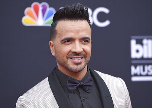 FILE - In this May 20, 2018 file photo, Luis Fonsi arrives at the Billboard Music Awards in Las Vegas. Telemundo is offering a first-of-its-kind virtual music special on Spanish-language media, featuring stars such as J Balvin, Luis Fonsi, Alejandro Sanz and Gloria Estefan.&#147;Concierto en Casa&#148; will air Saturday at 7 p.m. Eastern on Telemundo Network, UNIVERSO and across all its platforms. (Photo by Jordan Strauss/Invision/AP, File)