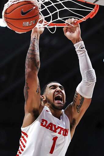 FILE - In this Feb. 22, 2020, file photo, Dayton's Obi Toppin (1) reacts as he dunks the ball in the second half of an NCAA college basketball game against Duquesne in Dayton, Ohio. Toppin was selected to The Associated Press All-America first team, Friday, March 20, 2020. (AP Photo/Aaron Doster, File)