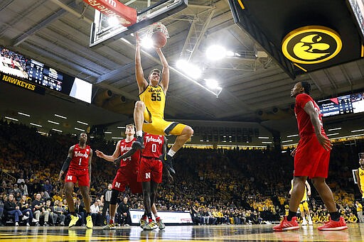 FILE - In this Feb. 8, 2020, file photo, Iowa center Luka Garza (55) dunks the ball during the second half of an NCAA college basketball game against Nebraska, in Iowa City, Iowa. Garza was selected to The Associated Press All-America first team, Friday, March 20, 2020.  (AP Photo/Charlie Neibergall, File)