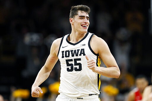 FILE - In this Feb. 20, 2020, file photo, Iowa center Luka Garza celebrates after making a basket during the first half of an NCAA college basketball game against Ohio State in Iowa City, Iowa. Garza was selected to The Associated Press All-America first team, Friday, March 20, 2020. (AP Photo/Charlie Neibergall, File)