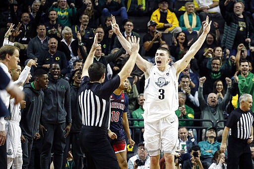 FILE - In this Jan. 9, 2020, file photo, Oregon's Payton Pritchard (3) celebrates a three-point basket that put the team ahead of Arizona during the second half of an NCAA college basketball game in Eugene, Ore. Pritchard was selected to The Associated Press All-America first team, Friday, March 20, 2020. (AP Photo/Thomas Boyd, File)