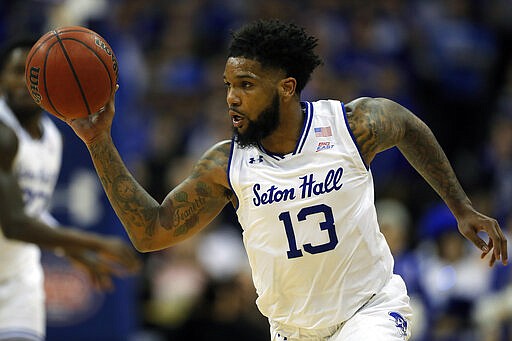 FILE - In this Feb. 2, 2020, file photo, Seton Hall guard Myles Powell (13) drives to the basket against Creighton during the second half of an NCAA college basketball game in Newark, N.J. Powell was selected to The Associated Press All-America first team, Friday, March 20, 2020. (AP Photo/Adam Hunger, File)