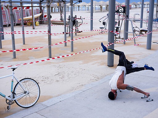 This Thursday, March 19, 2020 photo shows a free gym at Tel Aviv's beachfront wrapped in tape to prevent public access. Israel has reported a steady increase in confirmed cases despite imposing strict travel bans and quarantine measures more than two weeks ago. Authorities recently ordered the closure of all non-essential businesses and encouraged people to work from home. (AP Photo/Oded Balilty)