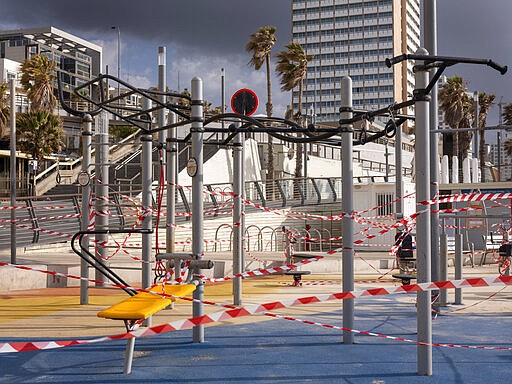 This Thursday, March 19, 2020 photo shows a free gym at Tel Aviv's beachfront wrapped in tape to prevent public access. Israel has reported a steady increase in confirmed cases despite imposing strict travel bans and quarantine measures more than two weeks ago. Authorities recently ordered the closure of all non-essential businesses and encouraged people to work from home. (AP Photo/Oded Balilty)