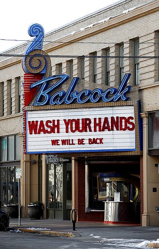 In this March 17, 2020 photo, the marquee at the Babcock Theatre in Billings, Mont. reads &quot;Wash your hands. We will be back&quot; on March 17, 2020. The theater closed in response to the coronavirus. (Casey Page/The Billings Gazette via AP)