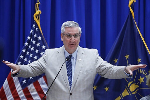 Gov. Eric Holcomb speaks during a news conference at the Statehouse, Friday, March 20, 2020, in Indianapolis. Holcomb said during the news conference with the state GOP and Democratic chairmen that the Indiana primary will be held on June 2 because of concern about the coronavirus pandemic. (AP Photo/Darron Cummings)