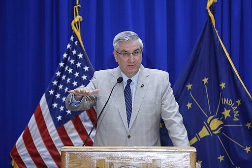 Gov. Eric Holcomb speaks during a news conference at the Statehouse, Friday, March 20, 2020, in Indianapolis. Holcomb said during the news conference with the state GOP and Democratic chairmen that the Indiana primary will be held on June 2 because of concern about the coronavirus pandemic. (AP Photo/Darron Cummings)