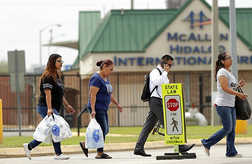 Pedestrians cross from Mexico to Texas at the McAllen Hidalgo International Bridge, Friday, March 20, 2020, in Hidalgo, Texas. President Donald Trump announced Friday the U.S.-Mexico border will be closed to nonessential travel to further help stem the spread of the coronavirus. (AP Photo/Eric Gay)