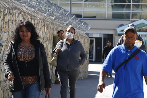 Commuters leave a customs checkpoint in El Paso, Texas on Friday, March 20, 2020. U.S. Shoppers continue to cross the border between that city and Ciudad Juarez, Mexico to purchase basic goods. Commuters are fewer, however, following school closures in El Paso. President Donald Trump and Mexican Foreign Secretary Marcelo Ebrard said the two governments will prohibit recreational and tourist travel starting Friday at midnight, similar to the restrictions put in place earlier this week along the U.S. and Canadian border. (AP Photo/Cedar Attanasio)