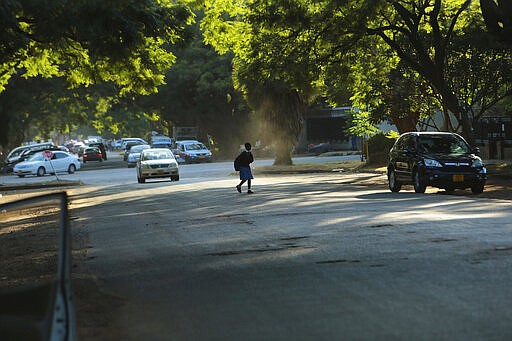 A young girl crosses the streets in Harare, Zimbabwe, Thursday, March, 19, 2020. More African countries have closed their borders as the coronavirus&#146; local spread threatens to turn the continent of 1.3 billion people into an alarming new front for the pandemic. For most people the new coronavirus causes only mild or moderate symptons.For some it can cause more severe illness, especially in older adults and pepole with existing health problems. (AP Photo/Tsvangirayi Mukwazhi)