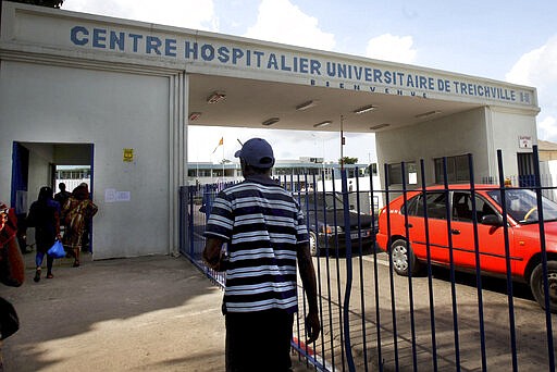 This photograph taken Thursday March 19, 2020, shows the entrance of the Treichville hospital in Abidjan, Ivory coast, where a suspected case of coronavirus is being treated.  Some countries around the world lack the equipment and trained health workers to respond to the threat of COVID-19 virus. For most people the virus causes mild or moderate symptoms, but for others it causes severe illness. (AP Photo/Diomande Ble Blonde)