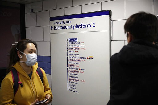 A sign in Green Park underground station shows amendments in red pen which stations have been closed in an attempt to reduce the spread of coronavirus in London, Friday, March 20, 2020. For most people, the new coronavirus causes only mild or moderate symptoms, such as fever and cough. For some, especially older adults and people with existing health problems, it can cause more severe illness, including pneumonia. (AP Photo/Matt Dunham)