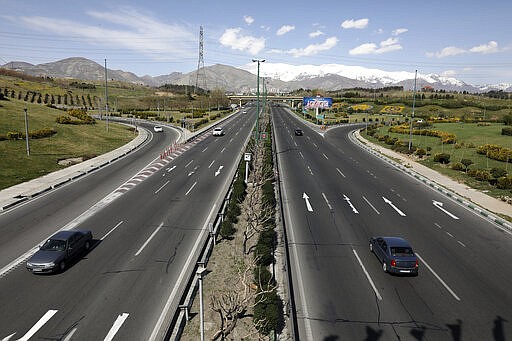 Cars drive in a highway in northern Tehran, Iran, Friday, March 20, 2020, on the first day of Iranian New Year, called Nowruz, or &quot;New Day&quot; in Farsi, the Persian holiday marking the the spring equinox. The new coronavirus has cut into the ancient Nowruz and has further slowed the Islamic Republic's economy. (AP Photo/Vahid Salemi)