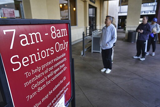 A sign is posted outside a Gelson's supermarket that opened special morning hours to serve seniors 60-years and older due to coronavirus concerns, Friday, March 20, 2020, in the Sherman Oaks section of Los Angeles on Friday, March 20, 2020. California's 40 million people are all but confined to their homes in the nation's biggest lockdown yet, as America's governors watch with growing alarm as southern Europe buckles under the strain of the coronavirus outbreak. (AP Photo/Richard Vogel)
