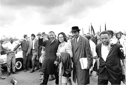 FILE - In this March 25, 1965, file photo, Dr. Martin Luther King Jr., and his wife, Coretta Scott King, lead off the final lap to the state capitol at Montgomery, Ala., as thousands of civil rights marchers joined in the walk to demand voter registration rights for blacks. A new project launched in March 2020 by the Hutchins Center for African and African American Research at Harvard University and a coalition of foundations seeks to bring online, interactive lessons about Selma and voting rights to students who are home from school due to the novel coronavirus. (AP Photo, File)