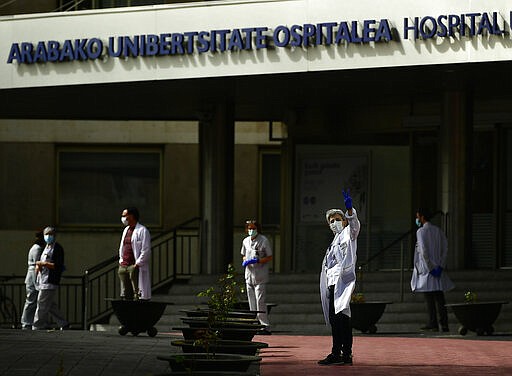 Health services staff members protest outside the Txagorritxu hospital demanding more protection equipment, after a Spanish nurse died Thursday from coronavirus COVID-19 in a hospital, in Vitoria, northern Spain, Friday March 20, 2020. Spain will mobilise 200 billion euros for workers and vulnerable citizens, Prime Minister Pedro Sanchez announced Tuesday. For many people the coronavirus causes mild or moderate symptoms, but for some it causes more severe illness, especially in older adults and people with existing health problems. (AP Photo/Alvaro Barrientos)