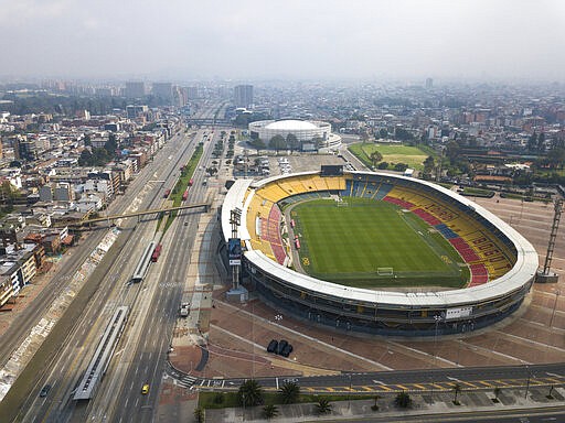 The usually busy avenue running along Nemesio Camacho stadium is empty in Bogota, Colombia, Friday, March 20, 2020. Residents in the capital of Colombia start a four-day simulated home lockdown drill, similar to one surrounding nations are using to stop the spread of the coronavirus. (AP Photo/Ivan Valencia)