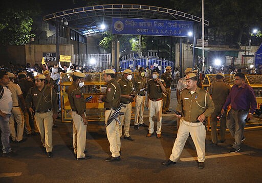 Policemen stand guard at the entrance of Tihar central prison where four men were sentenced to capital punishment in New Delhi, India, Friday, March 20, 2020. Four men sentenced to death for the gruesome gang rape and murder of a woman on a New Delhi bus in 2012 were hanged Friday, concluding a case that exposed the scope of sexual violence against women in India and prompted horrified Indians to demand swift justice. (AP Photo/Manish Swarup)