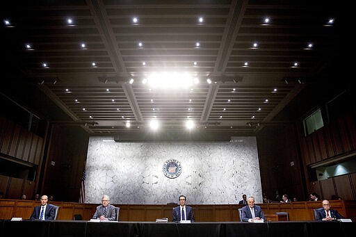 From left, Labor Secretary Eugene Scalia, Senate Majority Leader Mitch McConnell of Ky., Treasury Secretary Steven Mnuchin, Senate Minority Leader Sen. Chuck Schumer of N.Y., and White House chief economic adviser Larry Kudlow attend a a meeting to discuss the coronavirus relief bill on Capitol Hill, Friday, March 20, 2020, in Washington. (AP Photo/Andrew Harnik)